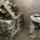 A three-legged table and a chest in a room in Pompeii.
